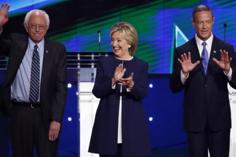 Democratic presidential candidates U.S. Senator Bernie Sanders (L), former Secretary of State Hillary Clinton (C) and former Maryland Governor Martin O'Malley react to the crowd before the start of the first official Democratic candidates debate of the 2016 presidential campaign in Las Vegas, Nevada October 13, 2015. REUTERS/Lucy Nicholson - RTS4CI6