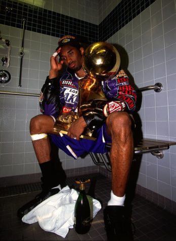 Kobe Bryant sits with the NBA Championship trophy after defeating the Philadelphia 76ers to win the 2001 NBA title on June 15, 2001 in Philadelphia, Pennsylvania. NOTE TO